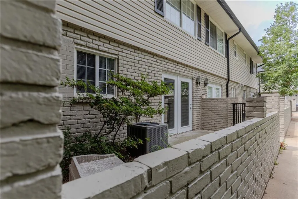 View of side of home featuring french doors and brick siding