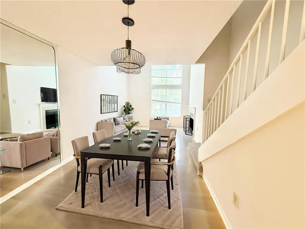 Dining room featuring a fireplace, a chandelier, and stairs