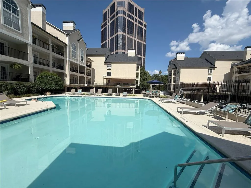 Community pool featuring a patio