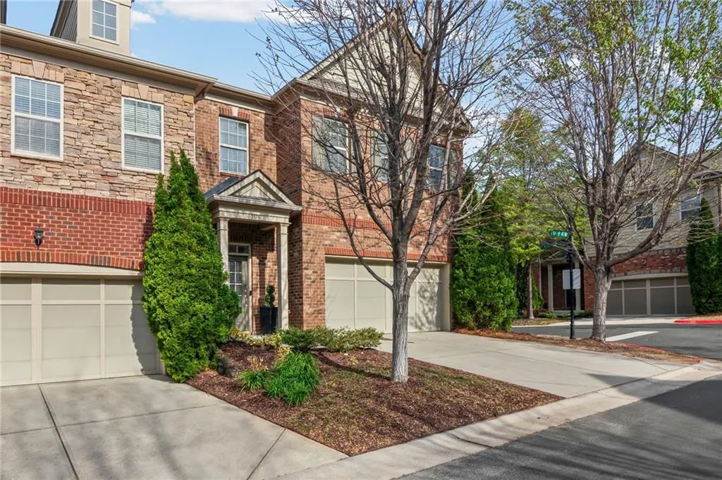 Traditional-style home featuring concrete driveway, a garage, and brick siding