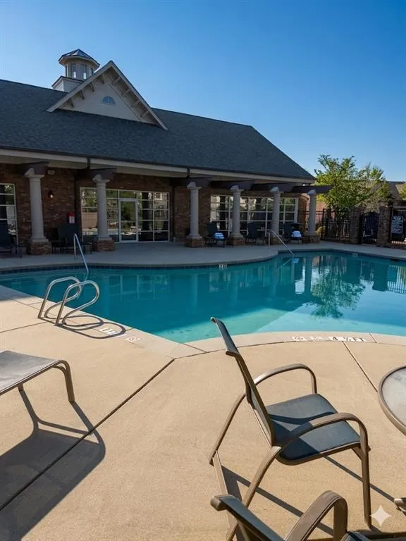Community pool with a patio