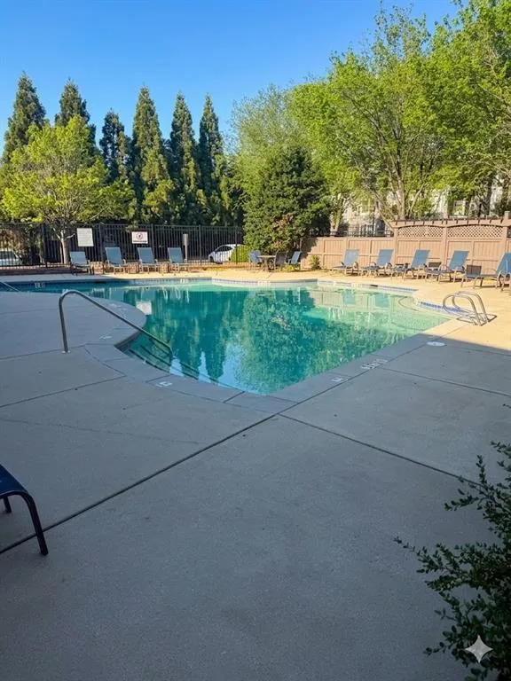 Community pool featuring a patio