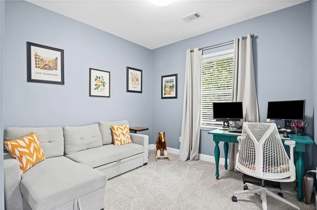 Sitting room with light carpet and baseboards