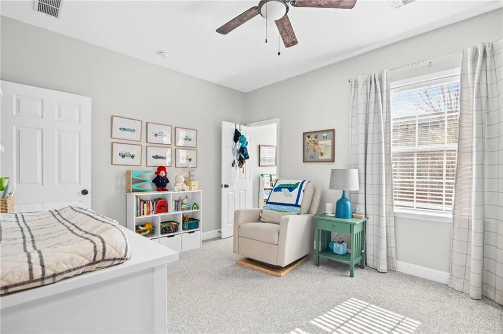Bedroom featuring light carpet and a ceiling fan