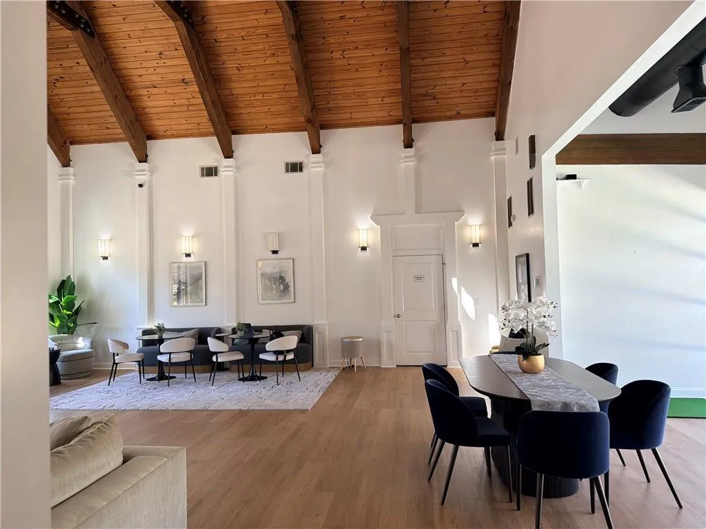 Clubhouse community room with a high wooden beamed ceiling and wood finished floors