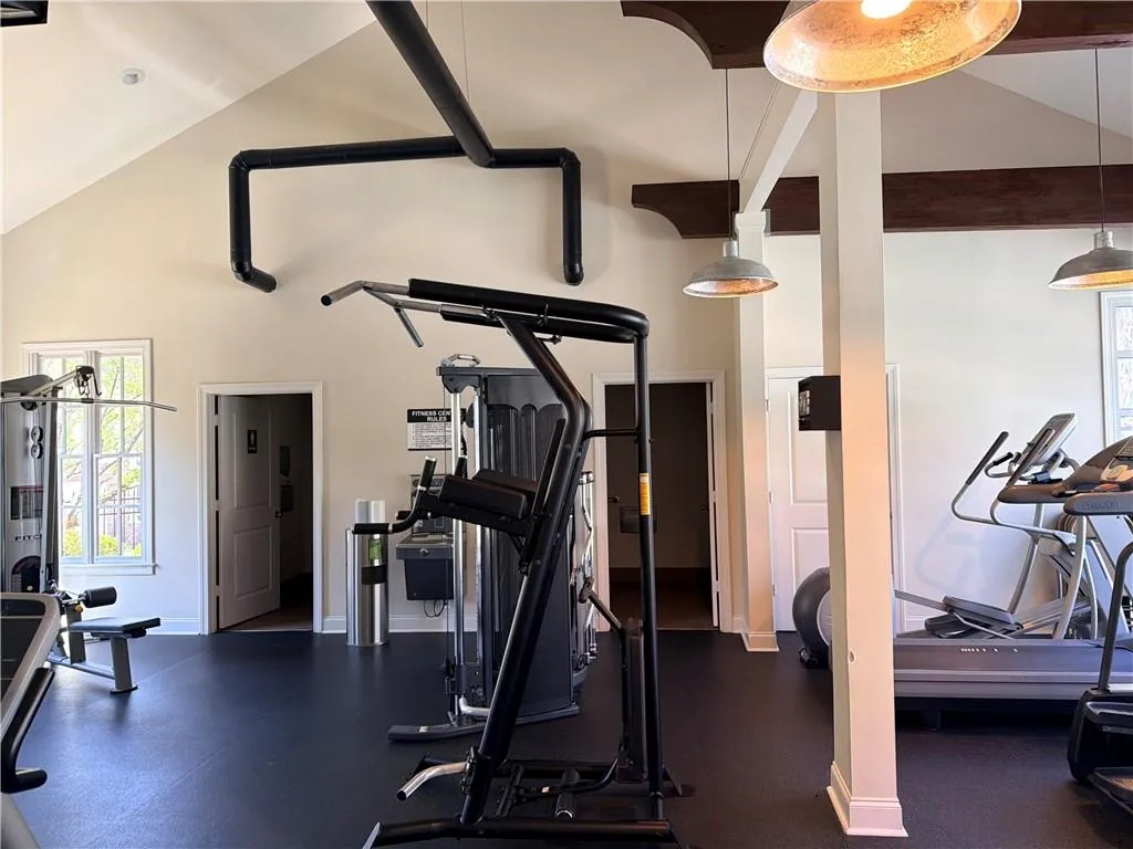 Clubhouse gym featuring lofted ceiling