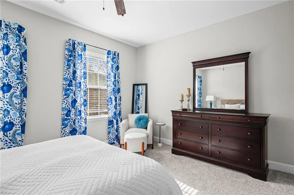 Bedroom with light carpet and a ceiling fan