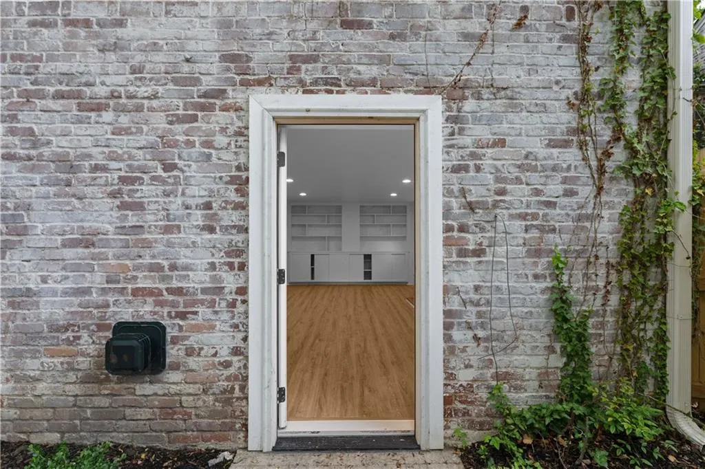 Entrance to property featuring brick siding