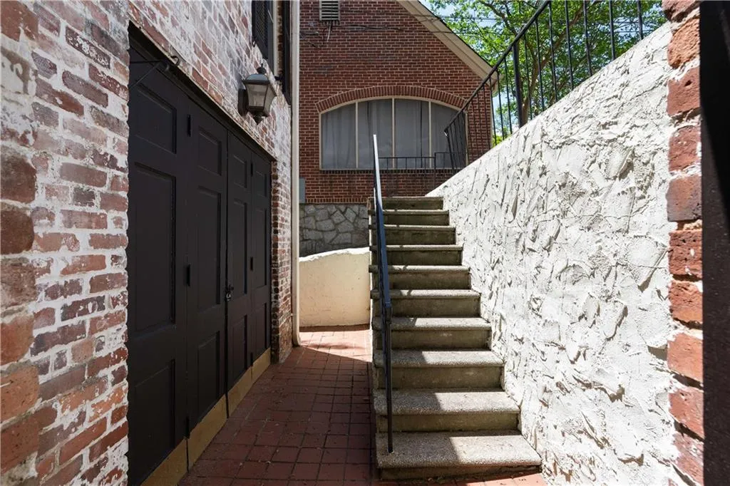 Property entrance featuring brick siding