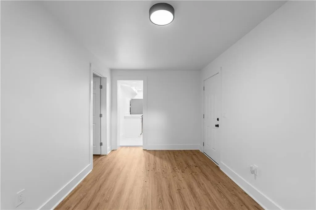 Empty room with baseboards and light wood-style floors