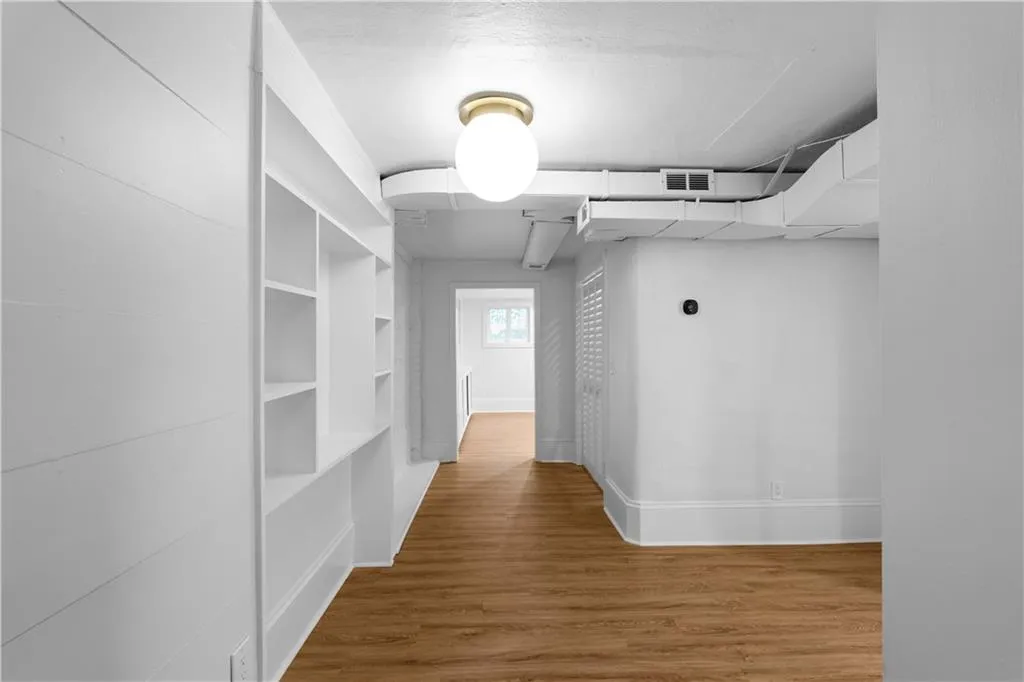 Hallway with wood finished floors and baseboards