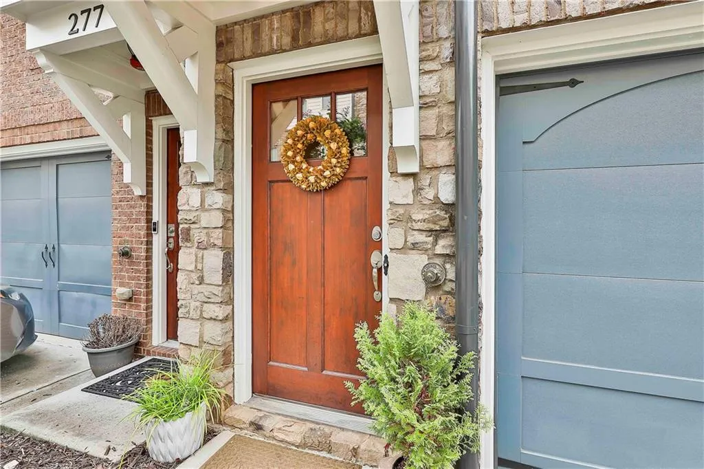 Entrance to property featuring stone siding