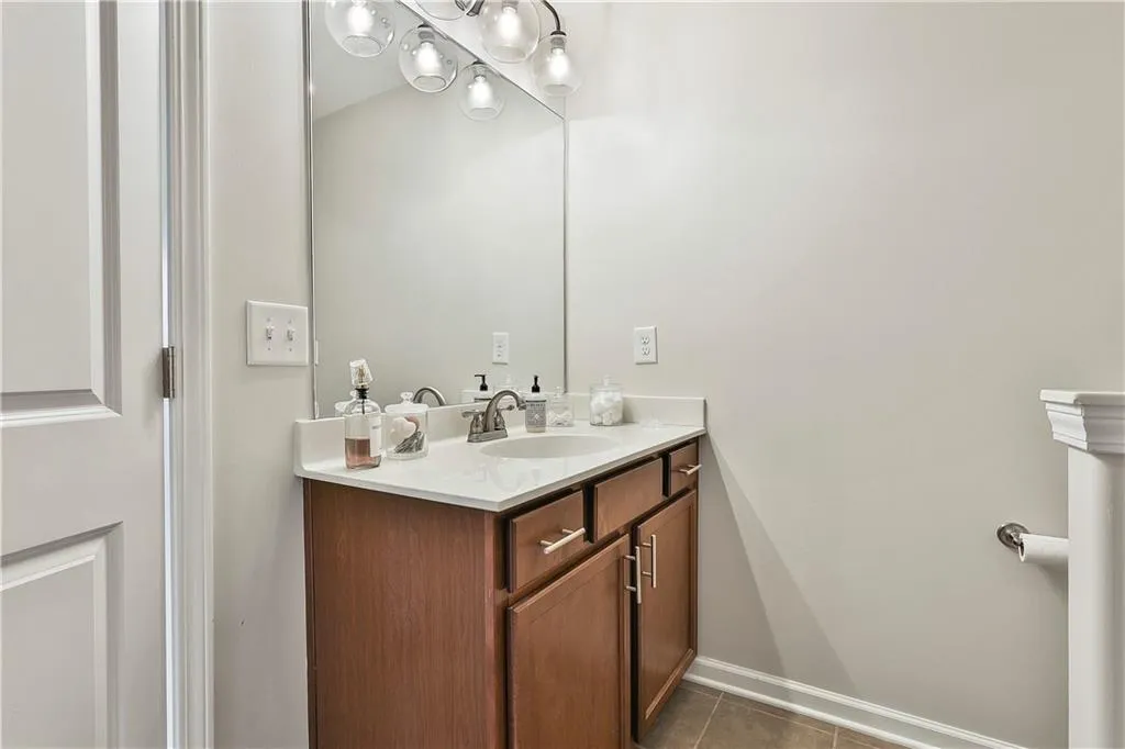 Bathroom with vanity and dark tile patterned flooring