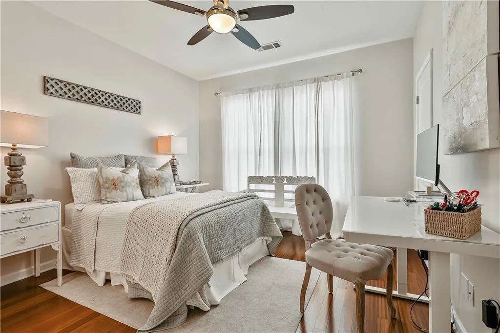 Bedroom featuring wood finished floors and a ceiling fan