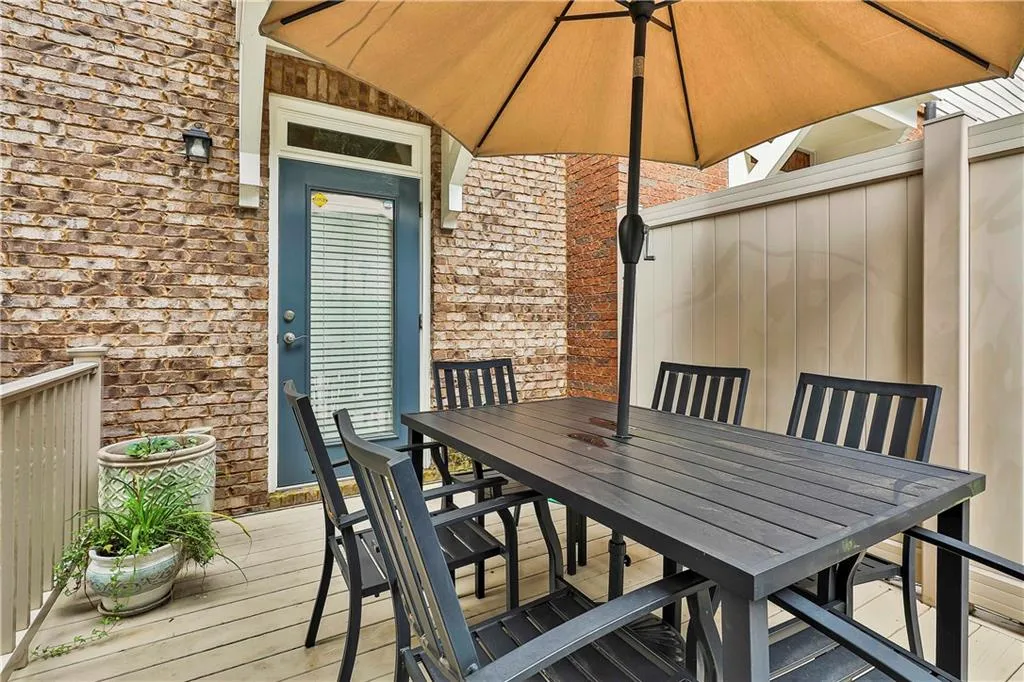 View of patio with outdoor dining area and a deck