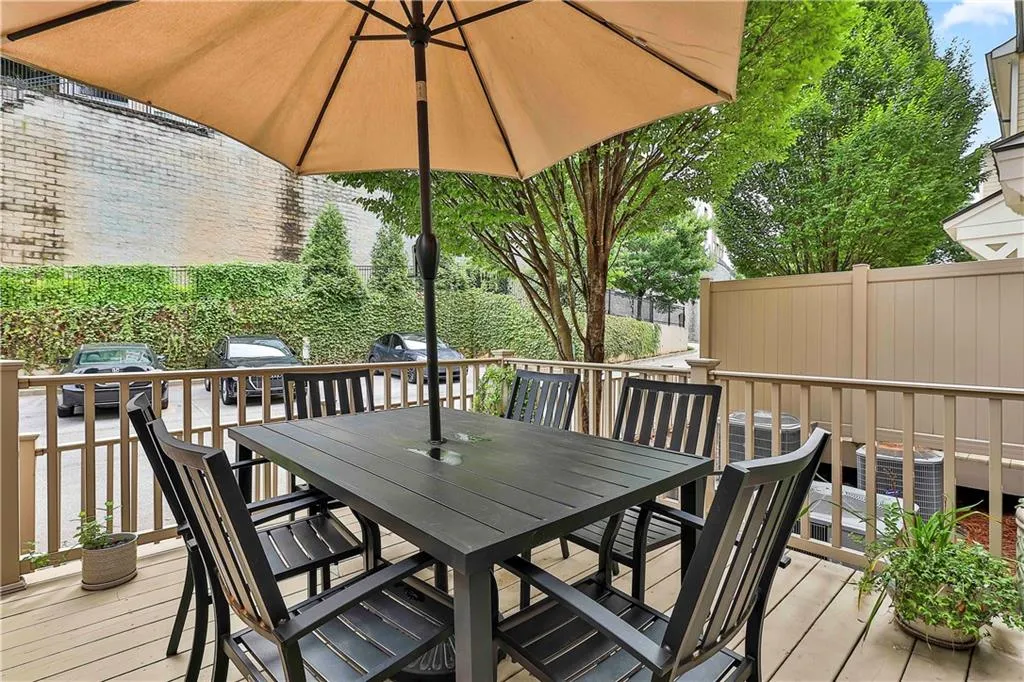 Wooden deck with a grill and outdoor dining area