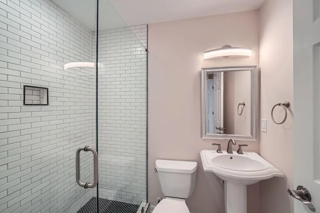 Bathroom featuring a stall shower and toilet