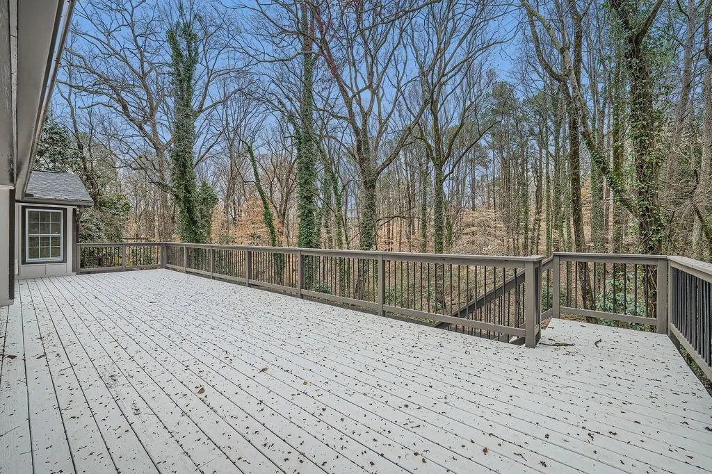 Wooden deck featuring a wooded view