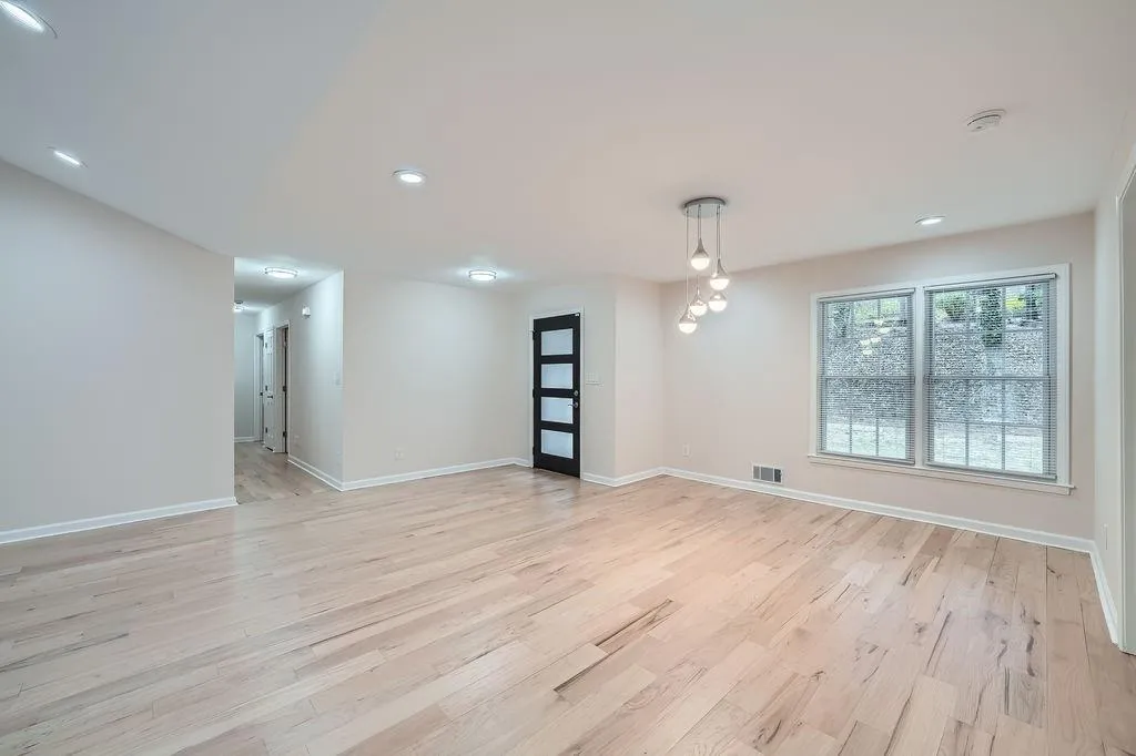 Empty room featuring recessed lighting, light wood-type flooring, visible vents, and baseboards
