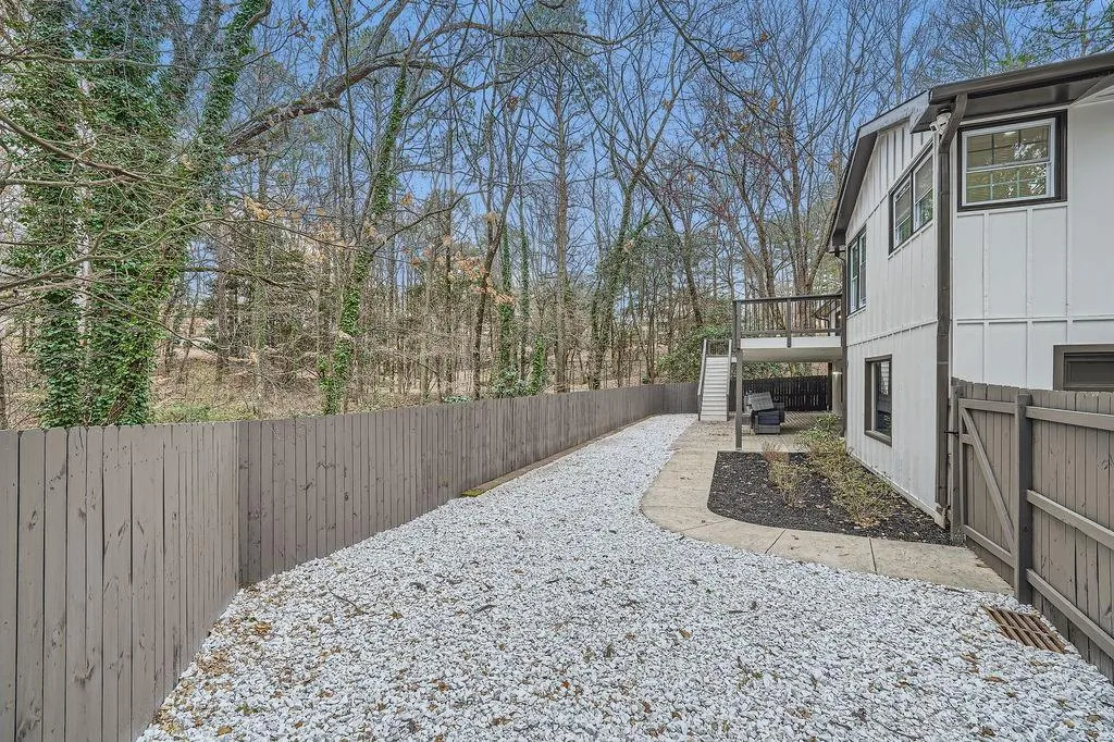 View of yard featuring stairway, a fenced backyard, and a wooden deck