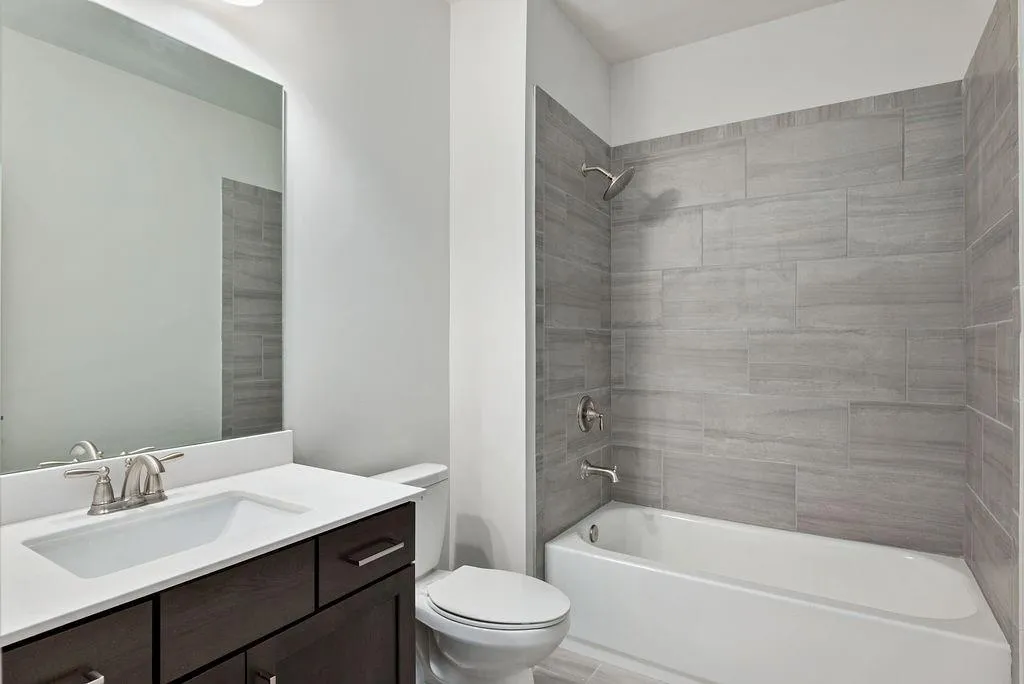 Bathroom with vanity and tub / shower combination