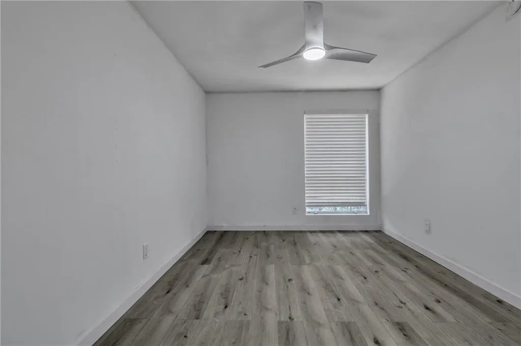 Unfurnished room featuring a ceiling fan and light wood finished floors