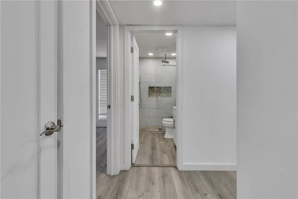 Corridor featuring light wood finished floors and recessed lighting