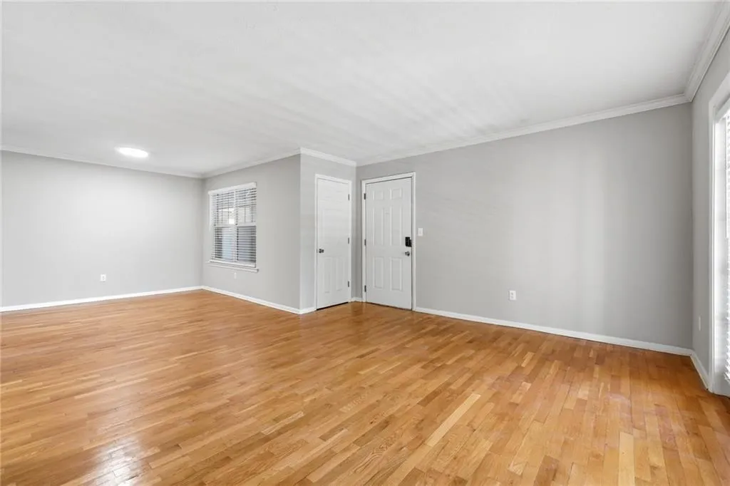 Spare room with light wood-style flooring and crown molding