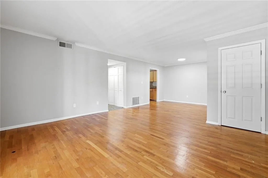 Spare room featuring ornamental molding and light wood-style flooring