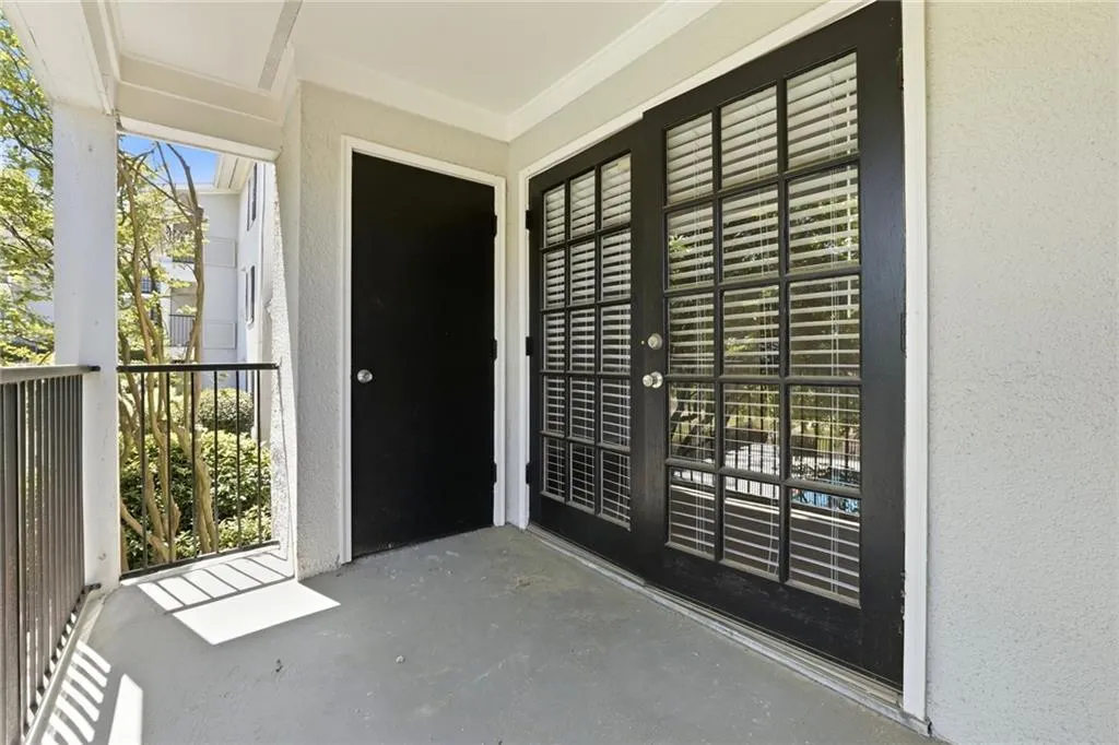 Entrance to property with stucco siding