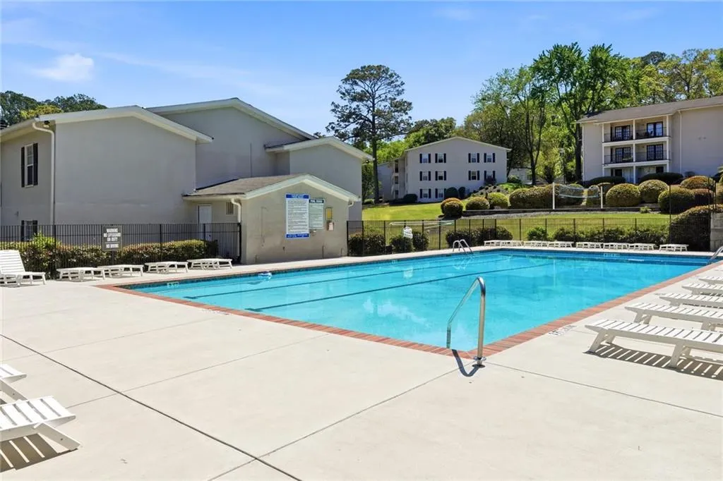 Community pool with a patio
