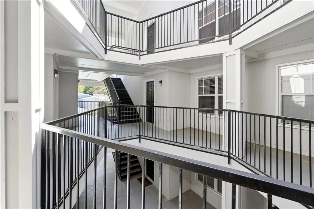 Stairs with a high ceiling, ornamental molding, and finished concrete flooring