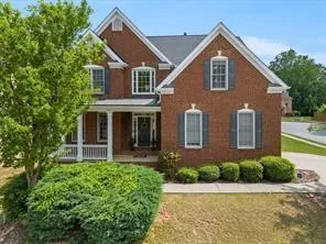 Brick facade with white trim accents and dark shutters
