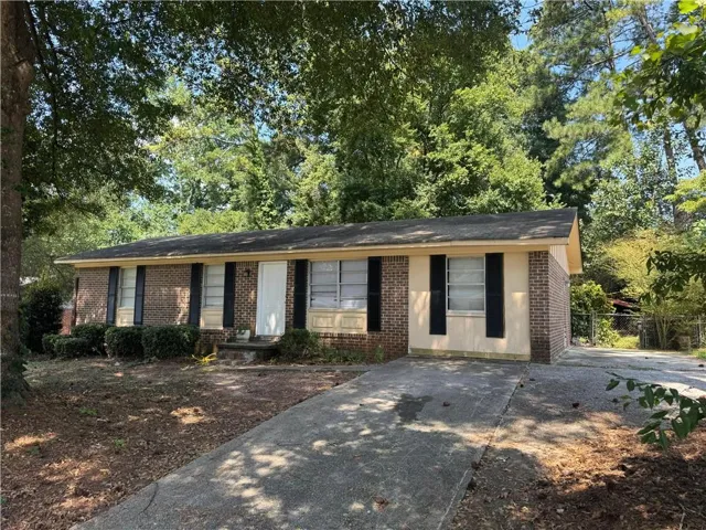 Brick and siding exterior with a concrete driveway