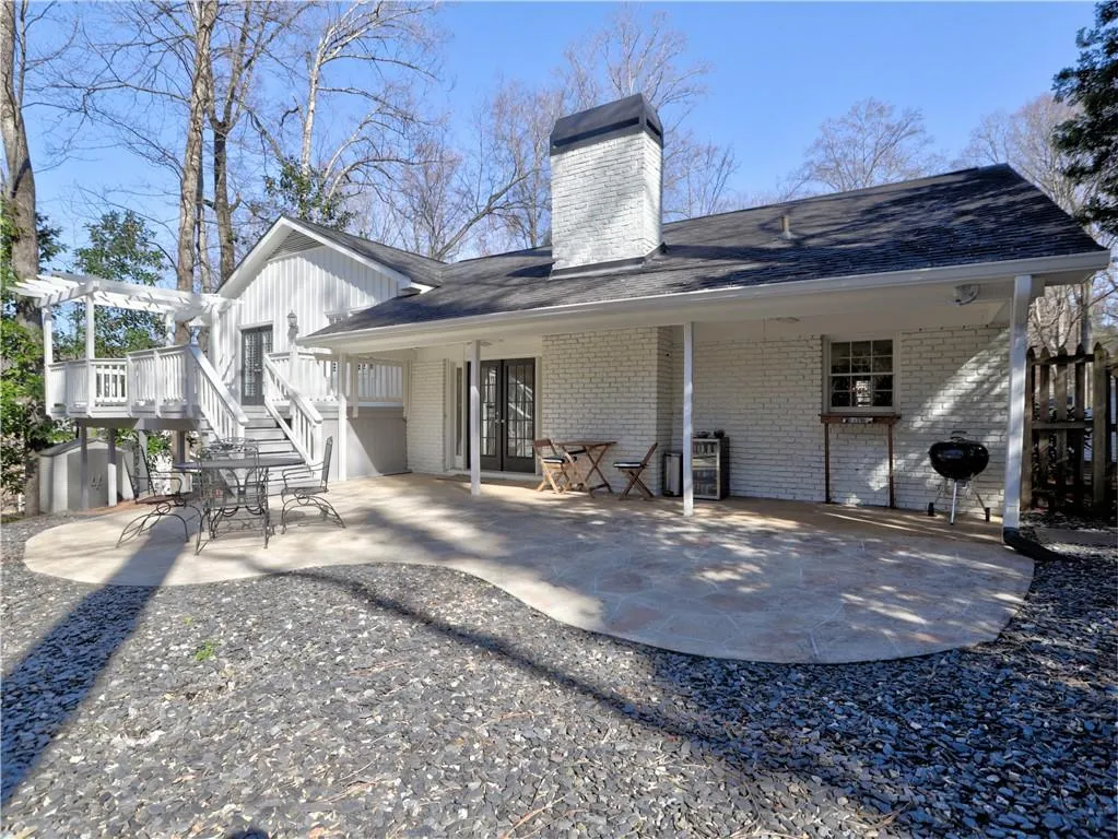 Rear view of house featuring a pergola and a patio area