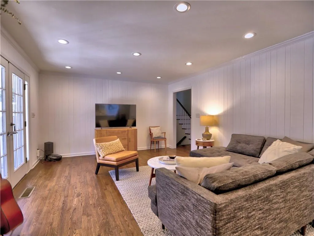 Living room featuring ornamental molding, hardwood / wood-style floors, and french doors