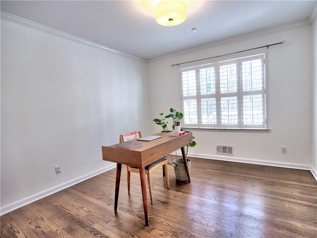 Office space featuring crown molding and dark hardwood / wood-style flooring