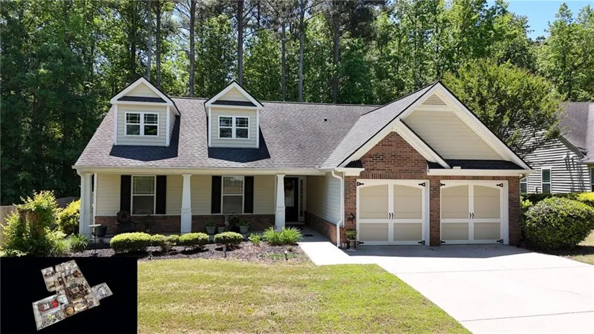 Ranch-style exterior featuring a covered front porch with white columns, light yellow siding, brick accents, and a dark shingle roof