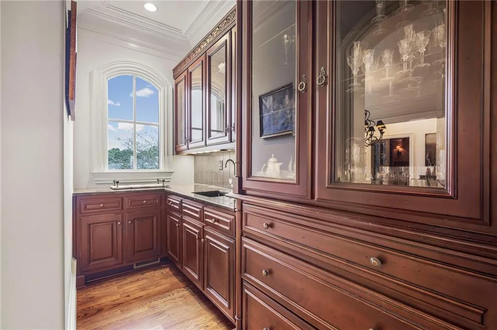 Custom cabinetry with glass-front uppers and ample storage
