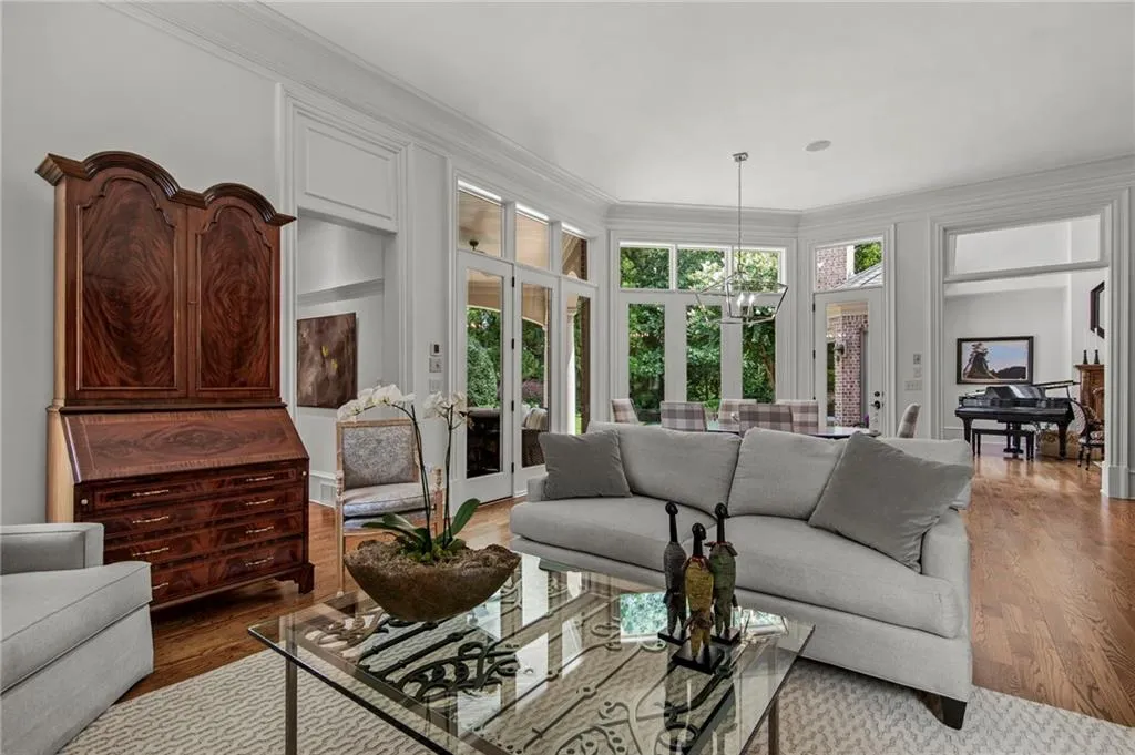 Hardwood flooring throughout, extensive crown molding, French doors, recessed lighting, and a grand piano