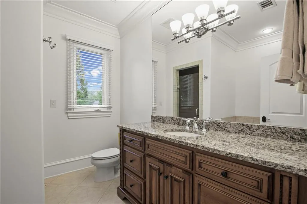 Secondary Bath 2 has  large Vanity with granite countertop, integrated sink, and wood-finish cabinetry, and seperate tub/shower