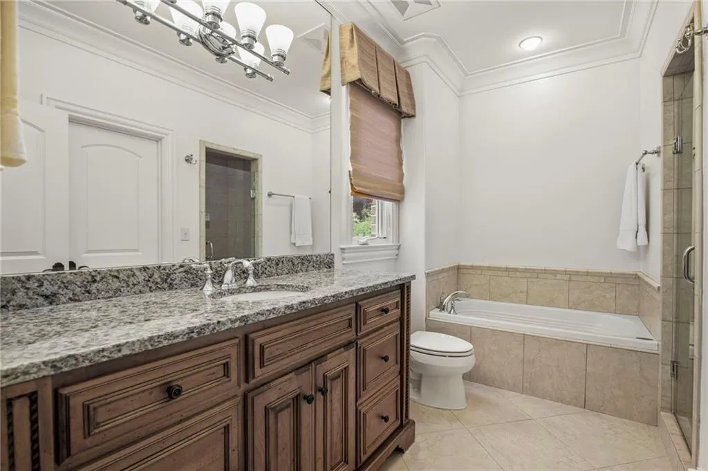 Virtually staged -- Painted vanity, changed countertop, hardware, and lighting only. Furnishings and decor are digitally rendered