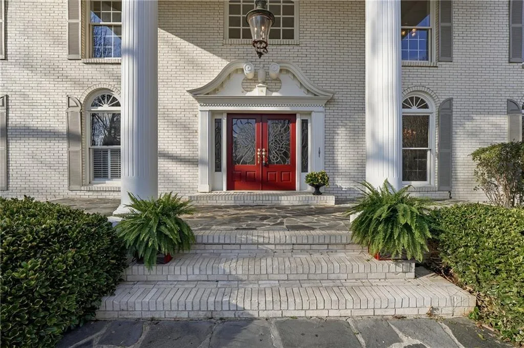 Entrance to property featuring french doors and brick siding