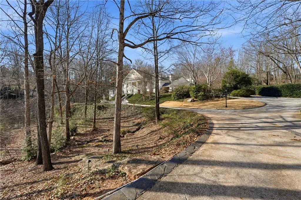 View of home's community featuring curved driveway