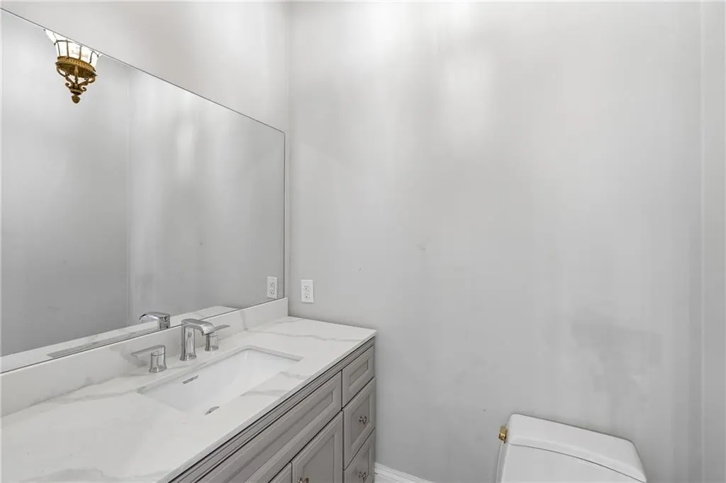 Half bath with vanity and toilet