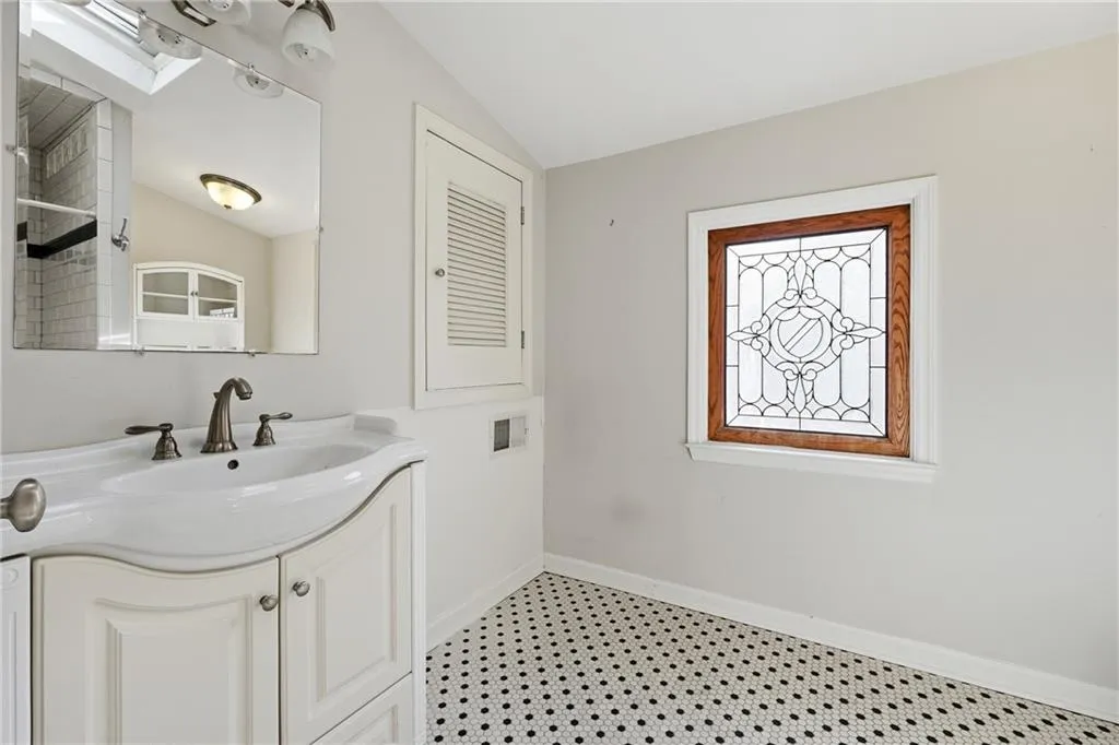 Bathroom with vanity and vaulted ceiling