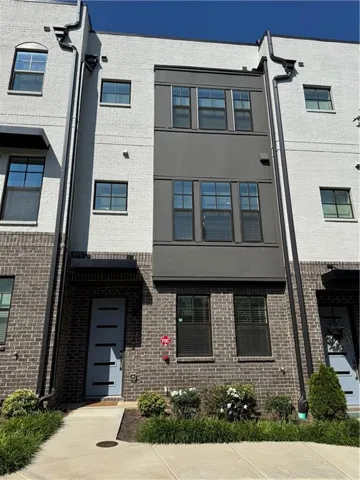 Three-story multi-unit dwelling with brick and painted brick facade