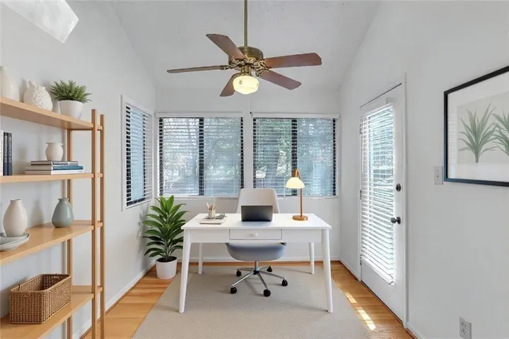 Fabulous, virtually staged sunroom with door to private deck.
