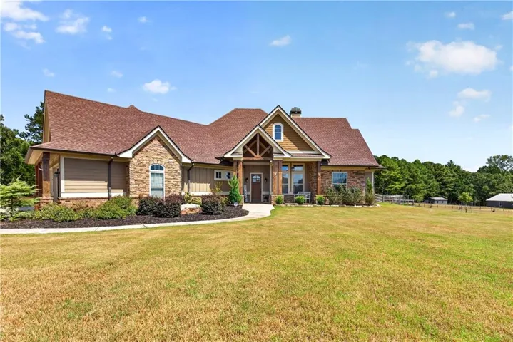 Siding exterior with stone accents and a prominent front gable