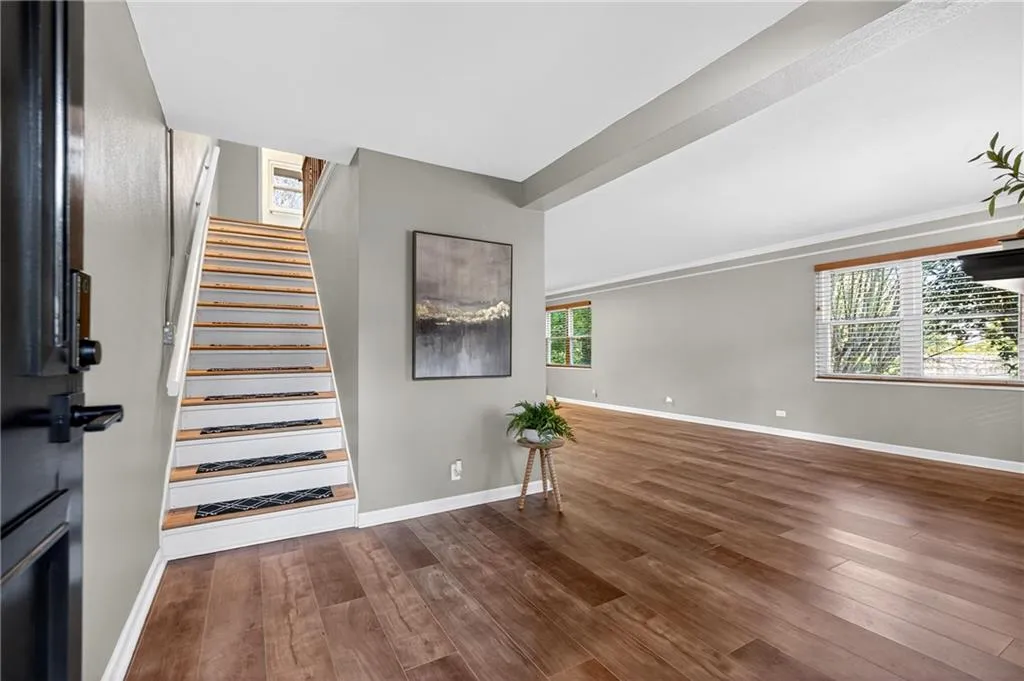 This welcoming entry offers a glimpse of the home's airy layout and warm, modern feel